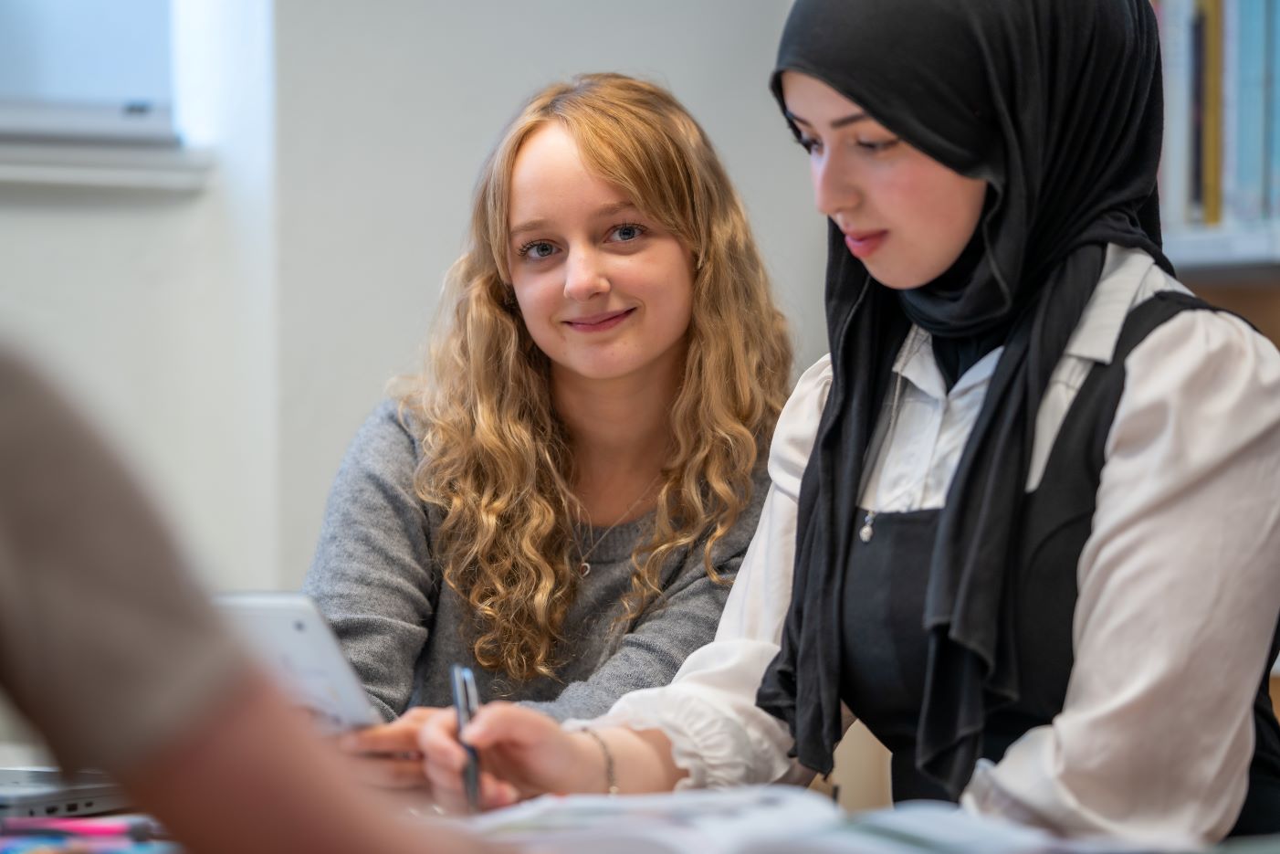 Picture of two students in a classroom.